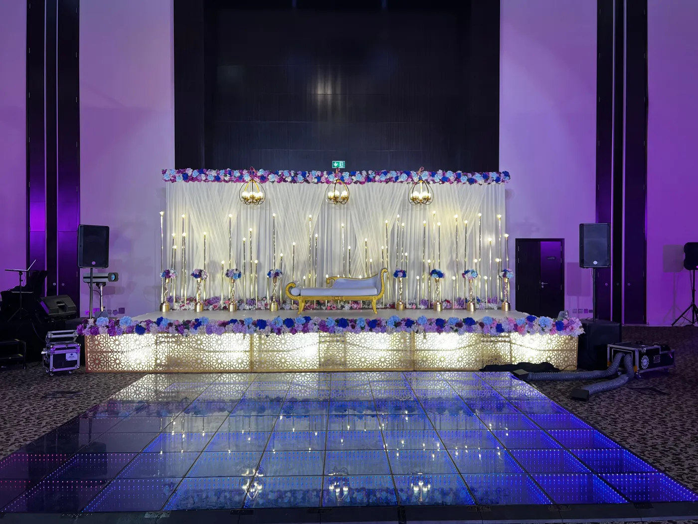 Wedding stage with candles, florals and an LED dance floor