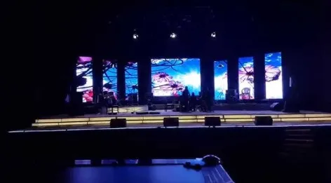 Stage with seven LED columns in a dark hall