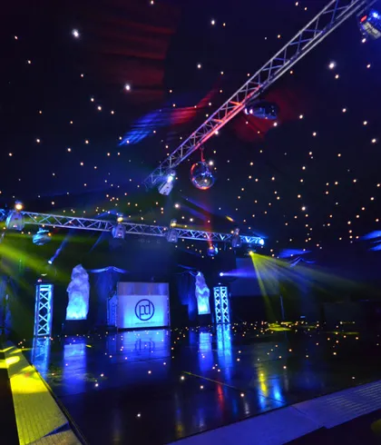 Truss structure with lighting above a DJ booth